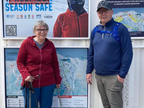 Tom & Una earing outdoor hiking gear and smiling and looking at the camera